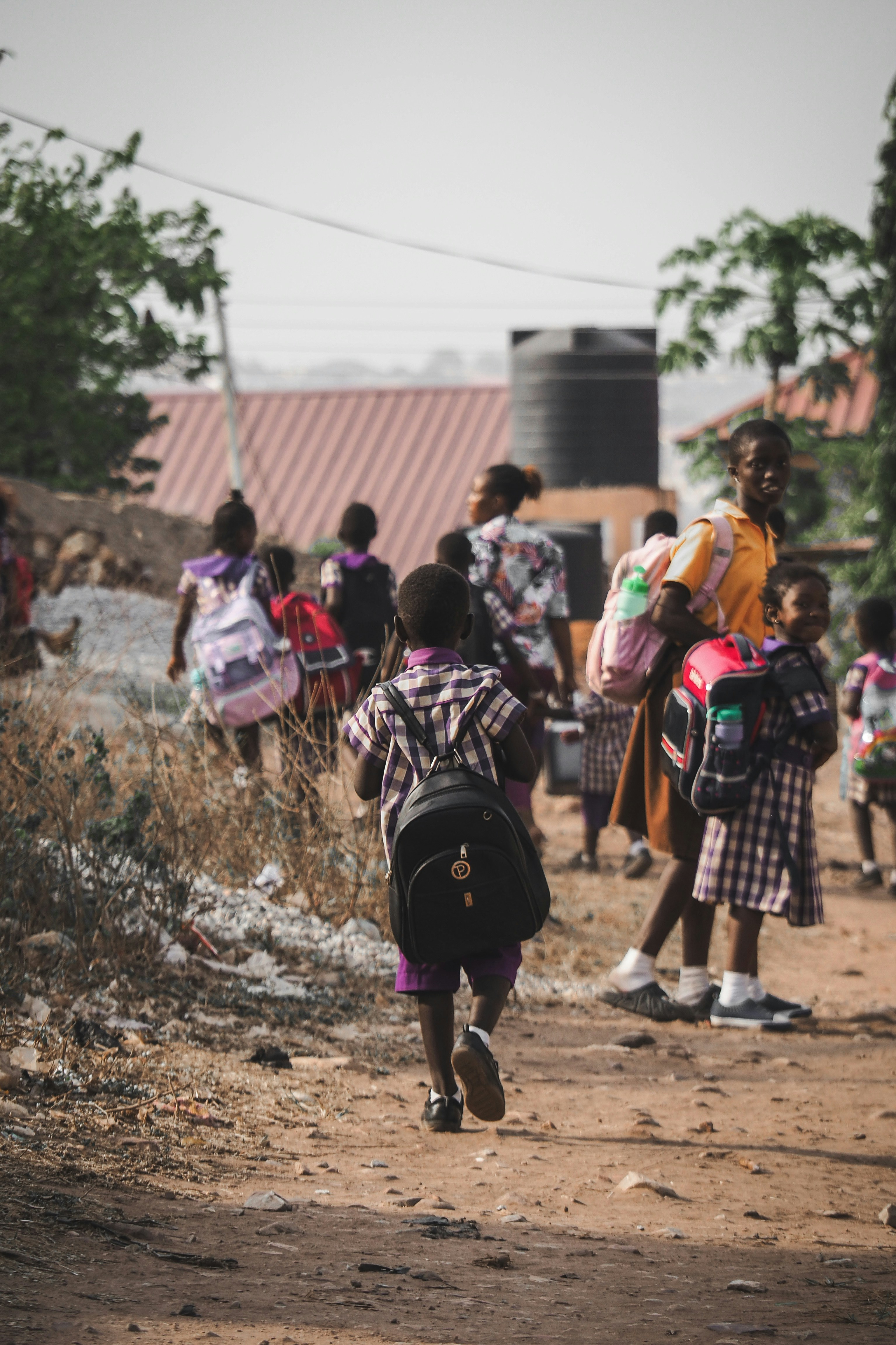 Children walking with joy after receiving school materials